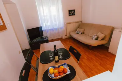 a living room with a table with a bowl of fruit at B&B Vransko 29 in Vransko
