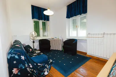 a living room with a couch and two chairs at B&B Vransko 29 in Vransko