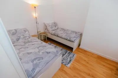 a small room with two beds and a lamp at B&B Vransko 29 in Vransko