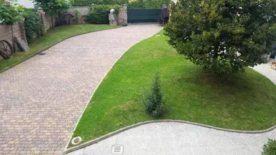 a brick walkway in a yard with green grass at B&B Vransko 29 in Vransko