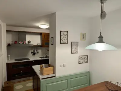 a kitchen with green cabinets and a white wall at Stairway to the castle in Ljubljana