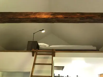 a room with a bunk bed and a ladder at Village Apartments in Šentilj