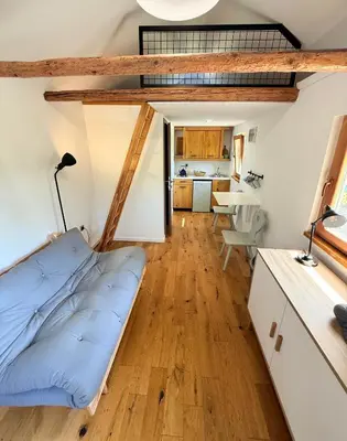 a living room with a couch and a kitchen at Village Apartments in Šentilj