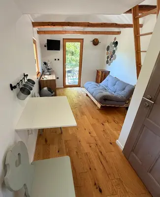 a living room with a couch and a table at Village Apartments in Šentilj