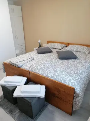 a bedroom with a large wooden bed with two boxes at Domačija Mirko in Miren