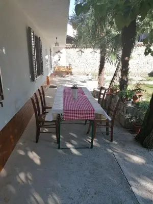 a table with a red and white checkered table cloth at Domačija Mirko in Miren
