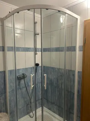 a shower with a glass door in a bathroom at Turistična kmetija Golej in Podčetrtek