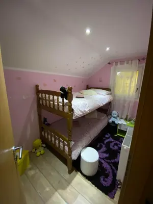 a childs bedroom with a bunk bed with pink walls at Turistična kmetija Golej in Podčetrtek