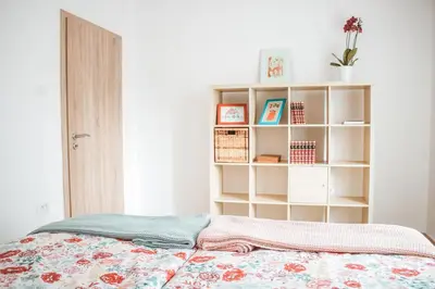a bedroom with a bed and a book shelf at Entoli Apartment in Podnanos