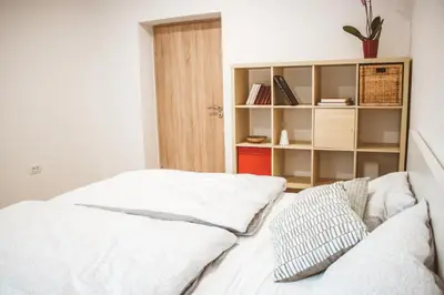 a bedroom with two beds and a book shelf at Entoli Apartment in Podnanos