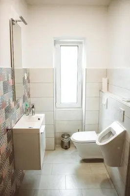 a white bathroom with a toilet and a sink at Entoli Apartment in Podnanos