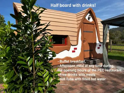a wooden dog house with ahair board with drinks at Glamping PEC - HALFBOARD in Selnica ob Dravi