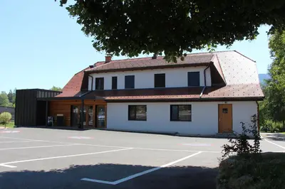 a building with a parking lot in front of it at Glamping PEC - HALFBOARD in Selnica ob Dravi