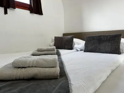 a bedroom with two beds with towels on them at Glamping PEC - HALFBOARD in Selnica ob Dravi