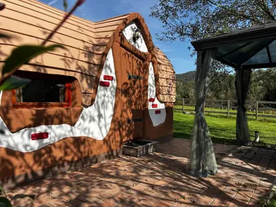 a tent with a wooden door in a field at Glamping PEC - HALFBOARD in Selnica ob Dravi