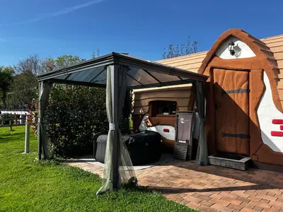 a black tent with a bed in a house at Glamping PEC - HALFBOARD in Selnica ob Dravi