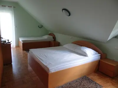 a bedroom with two beds in a attic at Rooms Hochkraut in Celje