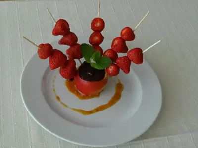 a plate with a dessert with strawberries on it at Rooms Hochkraut in Celje