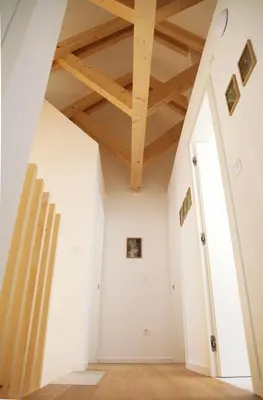 a room with white walls and wooden ceilings at Apartment Jurijana - New 4-Bedroom Triplex with Sauna & Garden in Bohinj