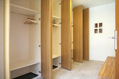a walk in closet with wooden doors and shelves at Apartment Jurijana - New 4-Bedroom Triplex with Sauna & Garden in Bohinj