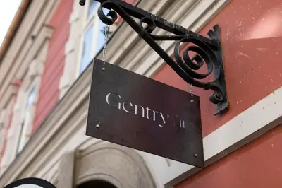 a sign hanging on the side of a building at Gentry11 Rooms&More in Maribor