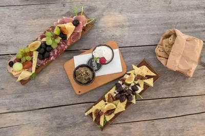 a table with a bunch of different types of food at Gentry11 Rooms&More in Maribor