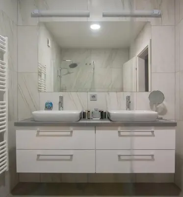 a bathroom with two sinks and a mirror at Villa de Roya in Rogaška Slatina