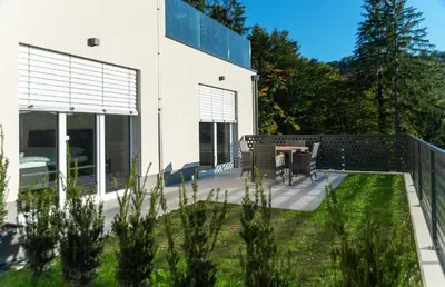 a patio with a table and chairs in front of a building at Villa de Roya in Rogaška Slatina
