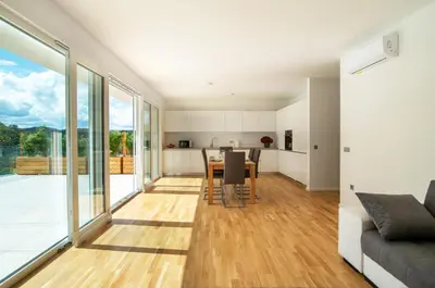 a kitchen and living room with a table and chairs at Villa de Roya in Rogaška Slatina