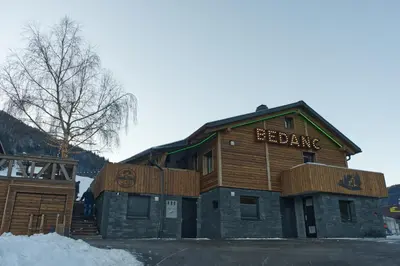 a building with a sign that reads beijing at Apartments Bedanc in Kranjska Gora