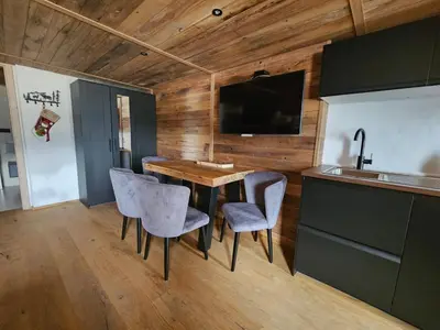 a kitchen with a table and chairs and a sink at Apartments Bedanc in Kranjska Gora