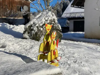 a fire hydrant with a cat on it in the snow at Apartma Jure in Zgornje Gorje