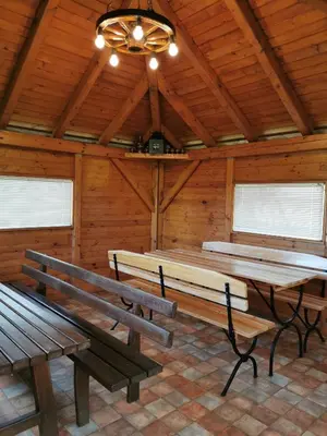 a room with wooden benches and a ceiling fan at Urlaub für die Seele - Erholung Pur in der Natur - Ferienhaus mit Infrarotkabine & RELAX-Raum in Rucmanci