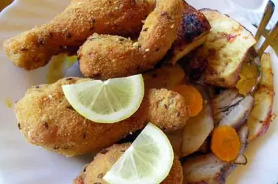 a plate of fried food with lemon slices on it at Urlaub für die Seele - Erholung Pur in der Natur - Ferienhaus mit Infrarotkabine & RELAX-Raum in Rucmanci