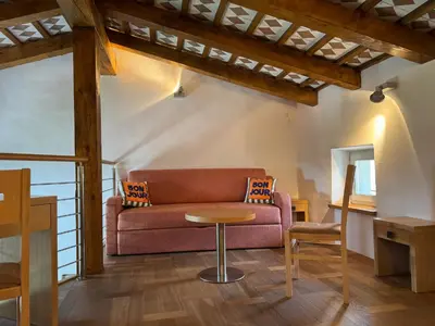 a living room with a couch and a table at SMARTnoOK Rooms and Apartment in Šmartno