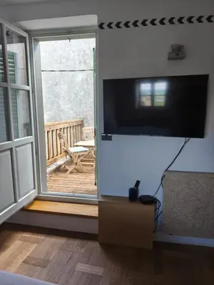 a living room with a flat screen tv on a wall at SMARTnoOK Rooms and Apartment in Šmartno