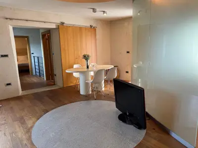 a living room with a tv and a table at SMARTnoOK Rooms and Apartment in Šmartno