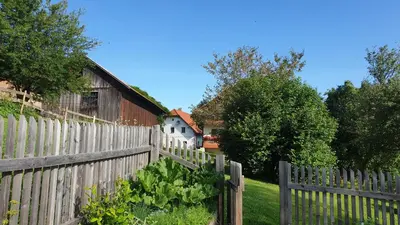 a wooden fence in front of a house at Apartma Lesjak - pobeg v naravo in Mozirje