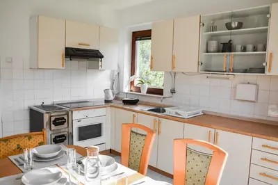 a kitchen with a table and chairs in it at House Marin - whole house in Maribor