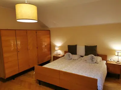 a bedroom with a large bed and two night stands at House Marin - whole house in Maribor