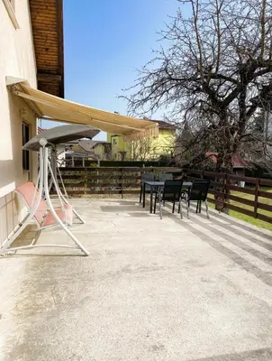a patio with a table and chairs under a canopy at House Marin - whole house in Maribor