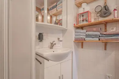 a white bathroom with a sink and towels at Vila Fani, Kostel - vacation house Pr' Vili Fani in Kostel