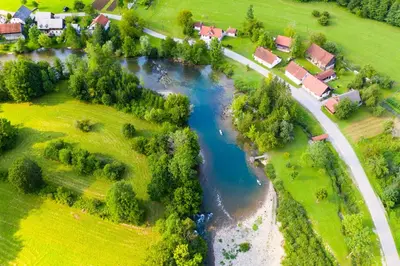 an aerial view of a village with a river at Vila Fani, Kostel - vacation house Pr' Vili Fani in Kostel