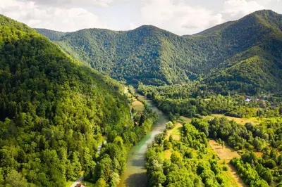 an aerial view of a river in a mountain valley at Vila Fani, Kostel - vacation house Pr' Vili Fani in Kostel