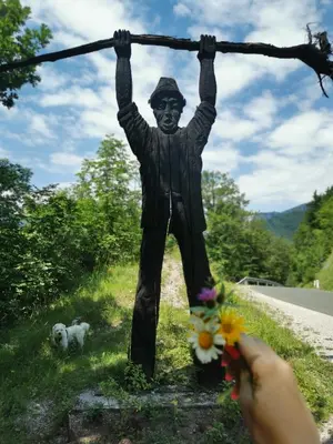 a person taking a picture of a statue at Vila Fani, Kostel - vacation house Pr' Vili Fani in Kostel