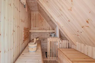 an inside of a wooden sauna with a bucket at Vila Fani, Kostel - vacation house Pr' Vili Fani in Kostel