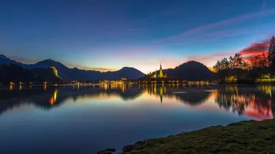 a view of a lake at sunset at Apartment Mavrica Bled, quiet location, with a view of the lake in Bled