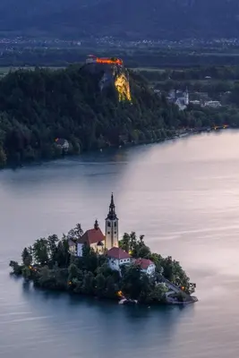 an island with a church in the middle of a lake at Apartment Mavrica Bled, quiet location, with a view of the lake in Bled