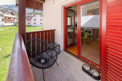 a balcony with a bench on a house at Timber Apartment in Bohinj