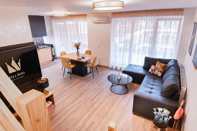 a living room with a couch and a table at Bella Mura Golden Apartment in Moravske Toplice